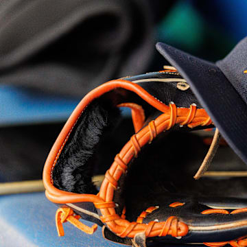 Apr 27, 2025; Kansas City, Missouri, USA; Houston Astros hat and glove in the dugout during the second inning against the Kansas City Royals at Kauffman Stadium. 