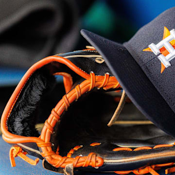 Apr 27, 2025; Kansas City, Missouri, USA; Houston Astros hat and glove in the dugout during the second inning against the Kansas City Royals at Kauffman Stadium. 