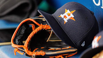 Apr 27, 2025; Kansas City, Missouri, USA; Houston Astros hat and glove in the dugout during the second inning against the Kansas City Royals at Kauffman Stadium. 