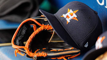 Houston Astros hat and glove in the dugout during the second inning against the Kansas City Royals at Kauffman Stadium. 