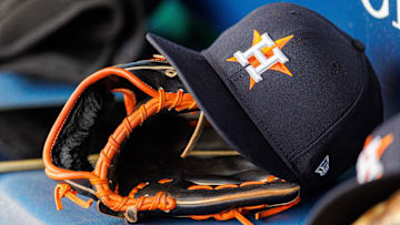 Apr 27, 2025; Kansas City, Missouri, USA; Houston Astros hat and glove in the dugout during the second inning against the Kansas City Royals at Kauffman Stadium. 