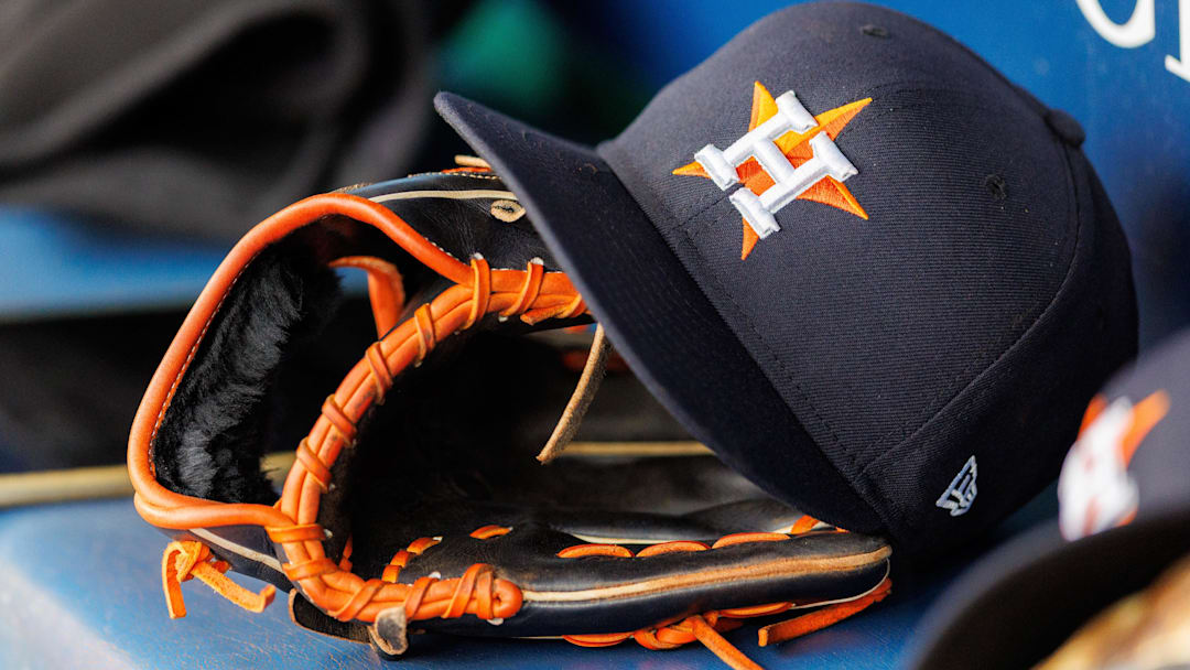 Apr 27, 2025; Kansas City, Missouri, USA; Houston Astros hat and glove in the dugout during the second inning against the Kansas City Royals at Kauffman Stadium. 