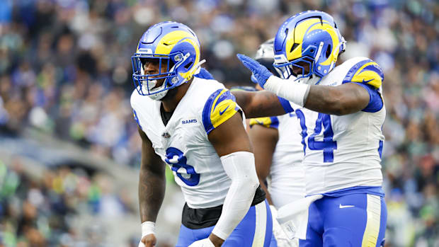 Jared Verse (8) celebrates with cornerback Cobie Durant (14) after a sack against the Seattle Seahawks.