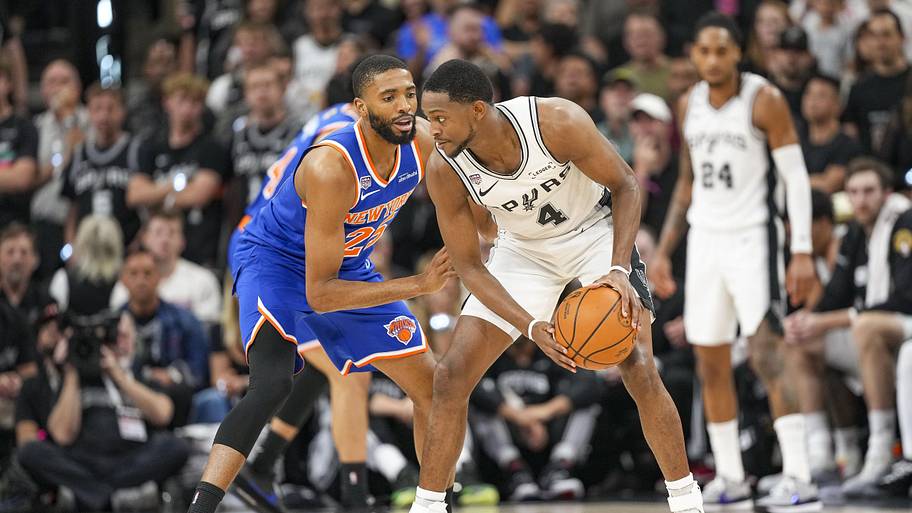 Spurs guard De’Aaron Fox looks to get around New York’s Mikal Bridges in the NBA Finals.