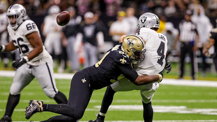 Oct 30, 2022; New Orleans, Louisiana, USA;  New Orleans Saints defensive end Cameron Jordan (94) tackles Las Vegas Raiders quarterback Derek Carr (4) just after he gets rid of the football during the second half at Caesars Superdome. Mandatory Credit: Stephen Lew-Imagn Images