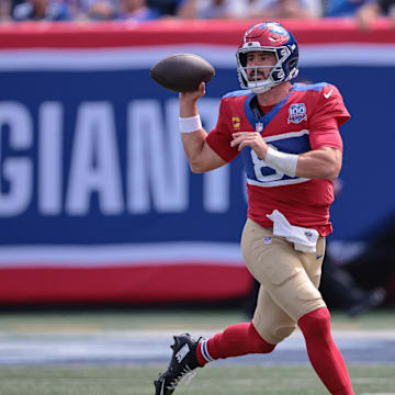 Sep 8, 2024; East Rutherford, New Jersey, USA; New York Giants quarterback Daniel Jones (8) rolls out to pass during the first half against the Minnesota Vikings at MetLife Stadium.  