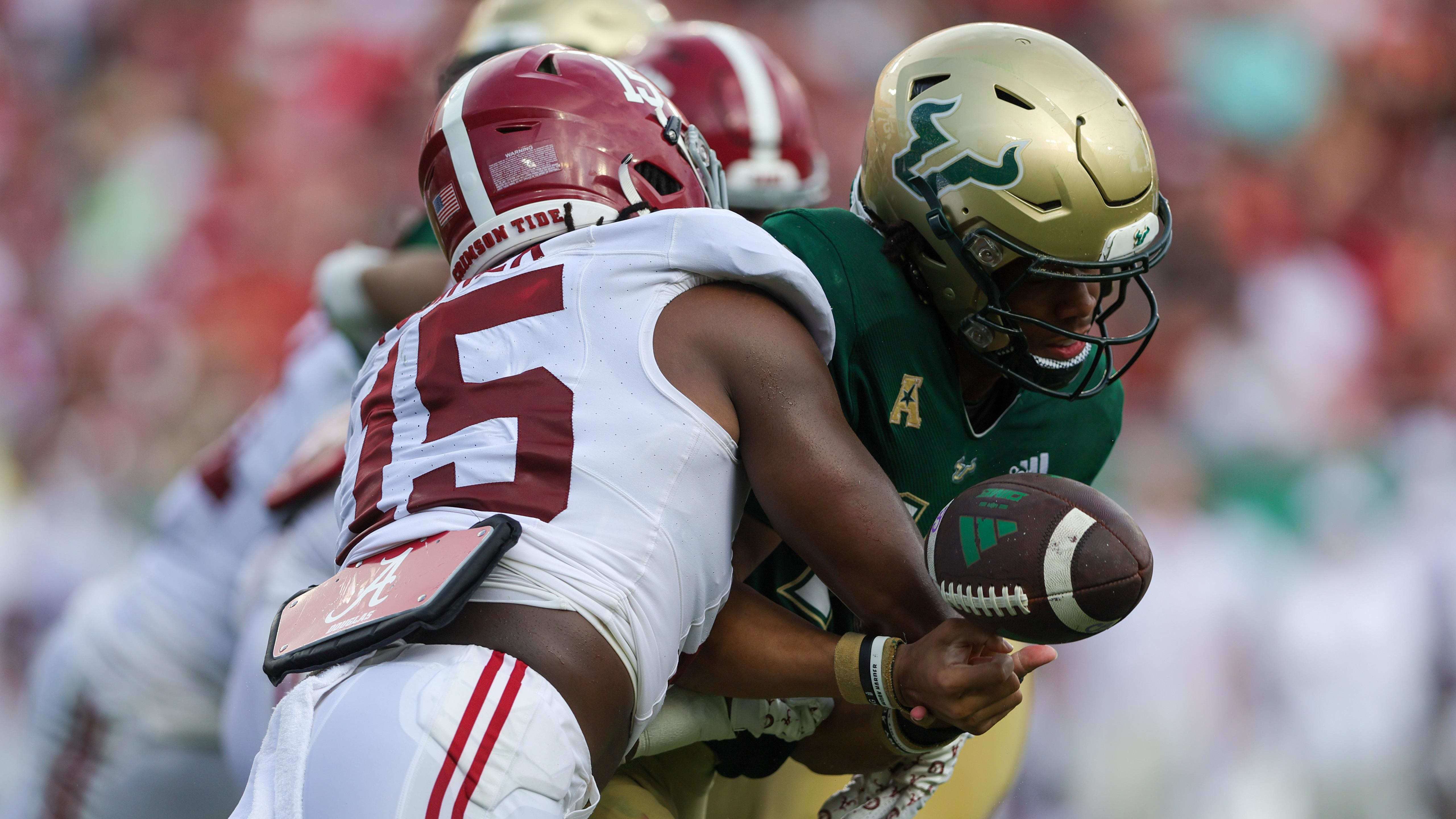 Alabama edge rusher Dallas Turner forces a fumble against South Florida.