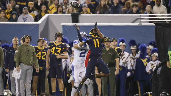 Nov 4, 2023; Morgantown, West Virginia, USA; West Virginia Mountaineers cornerback Beanie Bishop Jr. (11) defends against a pass intended for Brigham Young Cougars wide receiver Chase Roberts (2) during the second quarter at Mountaineer Field at Milan Puskar Stadium.