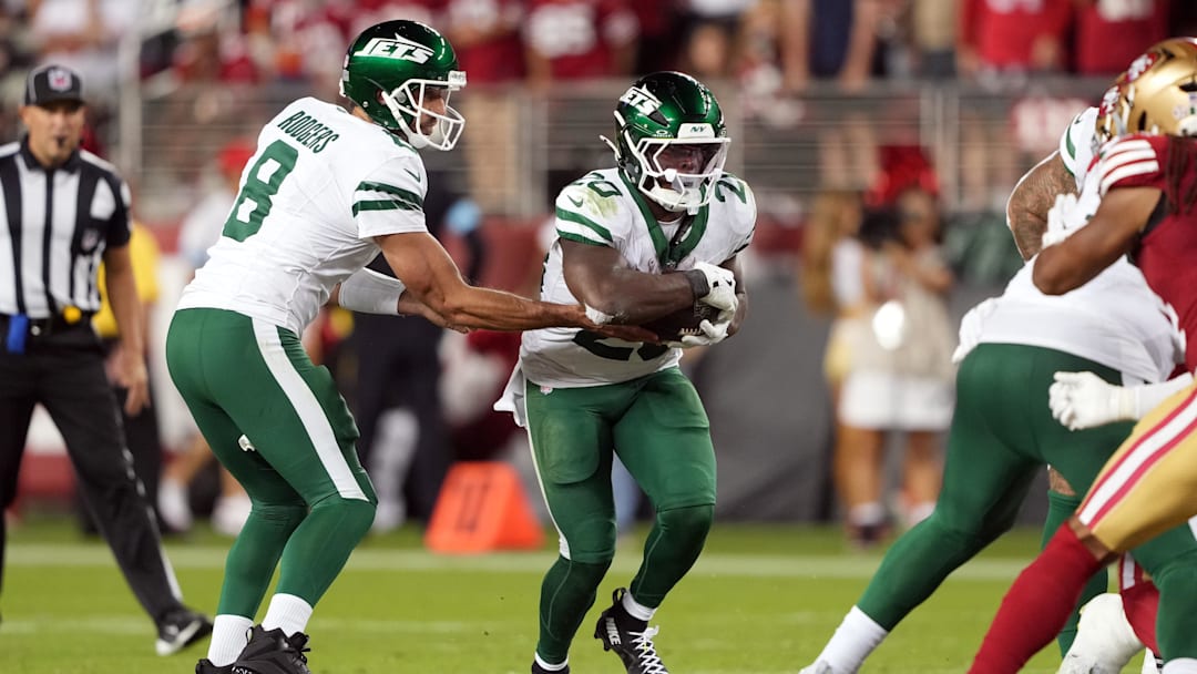 Sep 9, 2024; Santa Clara, California, USA; New York Jets quarterback Aaron Rodgers (8) hands the ball to running back Breece Hall (center) during the fourth quarter against the San Francisco 49ers at Levi's Stadium. 