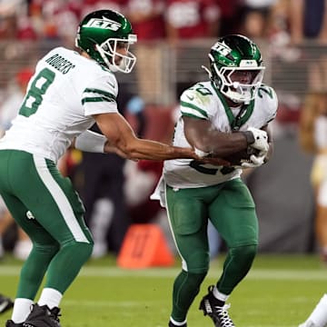 Sep 9, 2024; Santa Clara, California, USA; New York Jets quarterback Aaron Rodgers (8) hands the ball to running back Breece Hall (center) during the fourth quarter against the San Francisco 49ers at Levi's Stadium. 