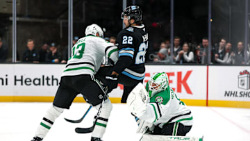 Dec 2, 2024; Salt Lake City, Utah, USA; Dallas Stars goaltender Casey DeSmith (1) catches the puck while defenseman Esa Lindell (23) tries to push Utah Hockey Club center Jack McBain (22) out of the way during the third period at Delta Center. Mandatory Credit: Chris Nicoll-Imagn Images