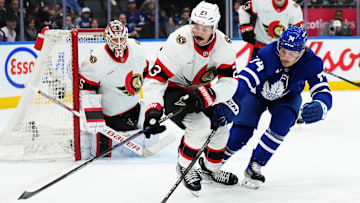 Nov 12, 2024; Toronto, Ontario, CAN; Ottawa Senators defenseman Travis Hamonic (23) battles for the puck with Toronto Maple Leafs center Bobby McMann (74) during the first period at Scotiabank Arena. Mandatory Credit: Nick Turchiaro-Imagn Images