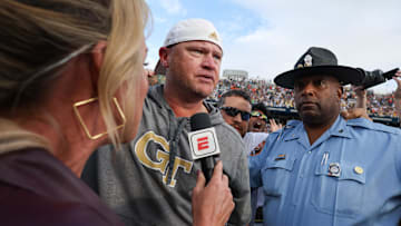 Nov 9, 2024; Atlanta, Georgia, USA; Georgia Tech Yellow Jackets head coach Brent Key talks to ESPN reporter Kris Budden after a victory over the Miami Hurricanes at Bobby Dodd Stadium at Hyundai Field. Mandatory Credit: Brett Davis-Imagn Images