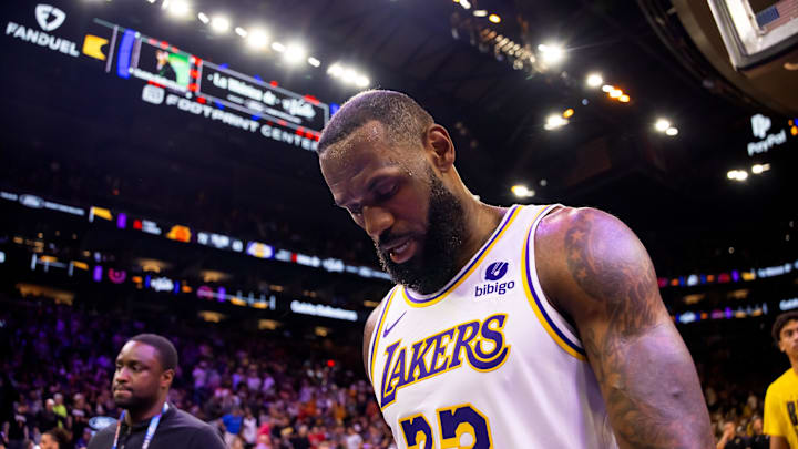 Feb 25, 2024; Phoenix, Arizona, USA; Los Angeles Lakers forward LeBron James (23) reacts as he walks off the court against the Phoenix Suns at Footprint Center. Mandatory Credit: Mark J. Rebilas-Imagn Images