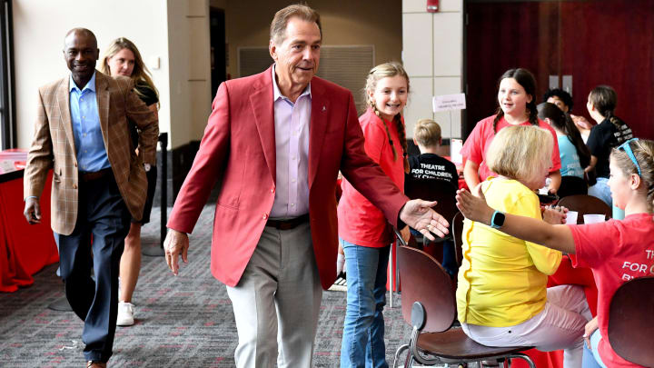 Nick Saban gives a “five” to one of the children as he arrives Wednesday, Aug. 14, 2024, at Bryant-Denny Stadium during the annual Nick’s Kids Foundation Luncheon.