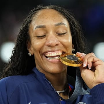 Aug 11, 2024; Paris, France; United States forward A'Ja Wilson (9) celebrates with the gold medal after defeating France in the women's gold medal game during the Paris 2024 Olympic Summer Games at Accor Arena. Mandatory Credit: Kyle Terada-Imagn Images