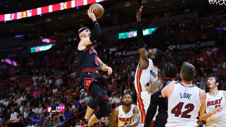 Apr 19, 2024; Miami, Florida, USA; Chicago Bulls guard Alex Caruso (6) shoots the basketball over Miami Heat guard Delon Wright (4) in the first quarter during a play-in game of the 2024 NBA playoffs at Kaseya Center. Mandatory Credit: Sam Navarro-USA TODAY Sports