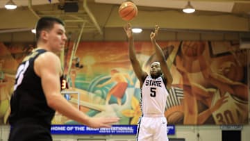 Nov 25, 2024; Lahaina, Hawaii, USA;  Michigan State Spartans guard Tre Holloman (5) takes a shot over the Colorado Buffaloes in the first half of an NCAA college basketball game at Lahaina Civic Center. Mandatory Credit: Marco Garcia-Imagn Images