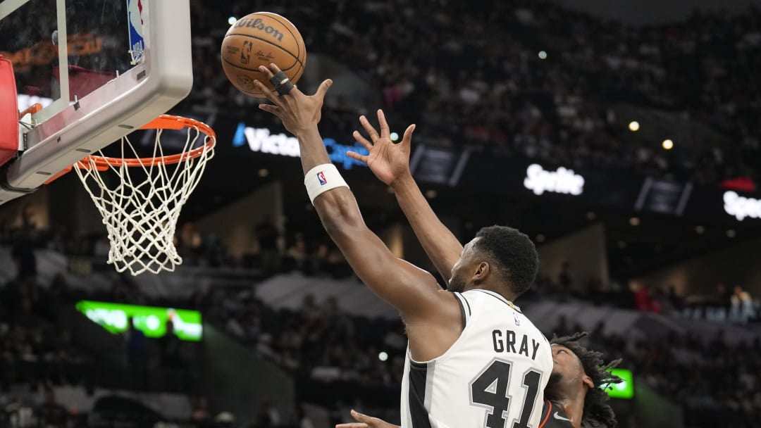 Apr 14, 2024; San Antonio, Texas, USA; San Antonio Spurs RaiQuan Gray (41) drives to the basket past Detroit Pistons center James Wiseman (13) during the second half at Frost Bank Center.