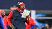 Dec 1, 2024; Foxborough, Massachusetts, USA; New England Patriots defensive coordinator Demarcus Covington works from the sideline during the second half against the Indianapolis Colts at Gillette Stadium. Mandatory Credit: Eric Canha-Imagn Images