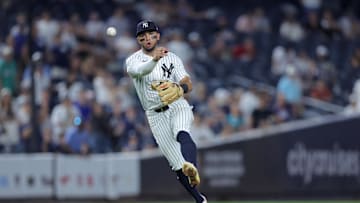 Jul 8, 2025; Bronx, New York, USA; New York Yankees third baseman Oswald Peraza (18) throws to first during the ninth inning against the Seattle Mariners at Yankee Stadium. Mandatory Credit: Brad Penner-Imagn Images