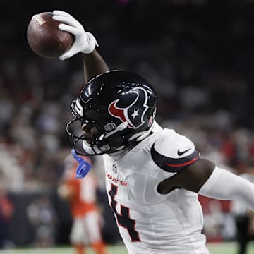 Sep 15, 2024; Houston, Texas, USA; Houston Texans cornerback Kamari Lassiter (4) celebrates his interception against the Chicago Bears in the second half at NRG Stadium. Mandatory Credit: Thomas Shea-Imagn Images