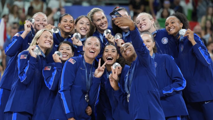 Aug 11, 2024; Paris, France; United States players celebrate with their silver medals on the podium after the women's volleyball gold medal match during the Paris 2024 Olympic Summer Games at South Paris Arena.