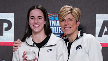 Apr 4, 2024; Cleveland, OH, USA; Iowa Hawkeyes guard Caitlin Clark (left) poses with associate head coach Jan Jensen after being selected as the AP Player of the Year at a press conference at Rocket Mortgage FieldHouse. Mandatory Credit: Kirby Lee-Imagn Images