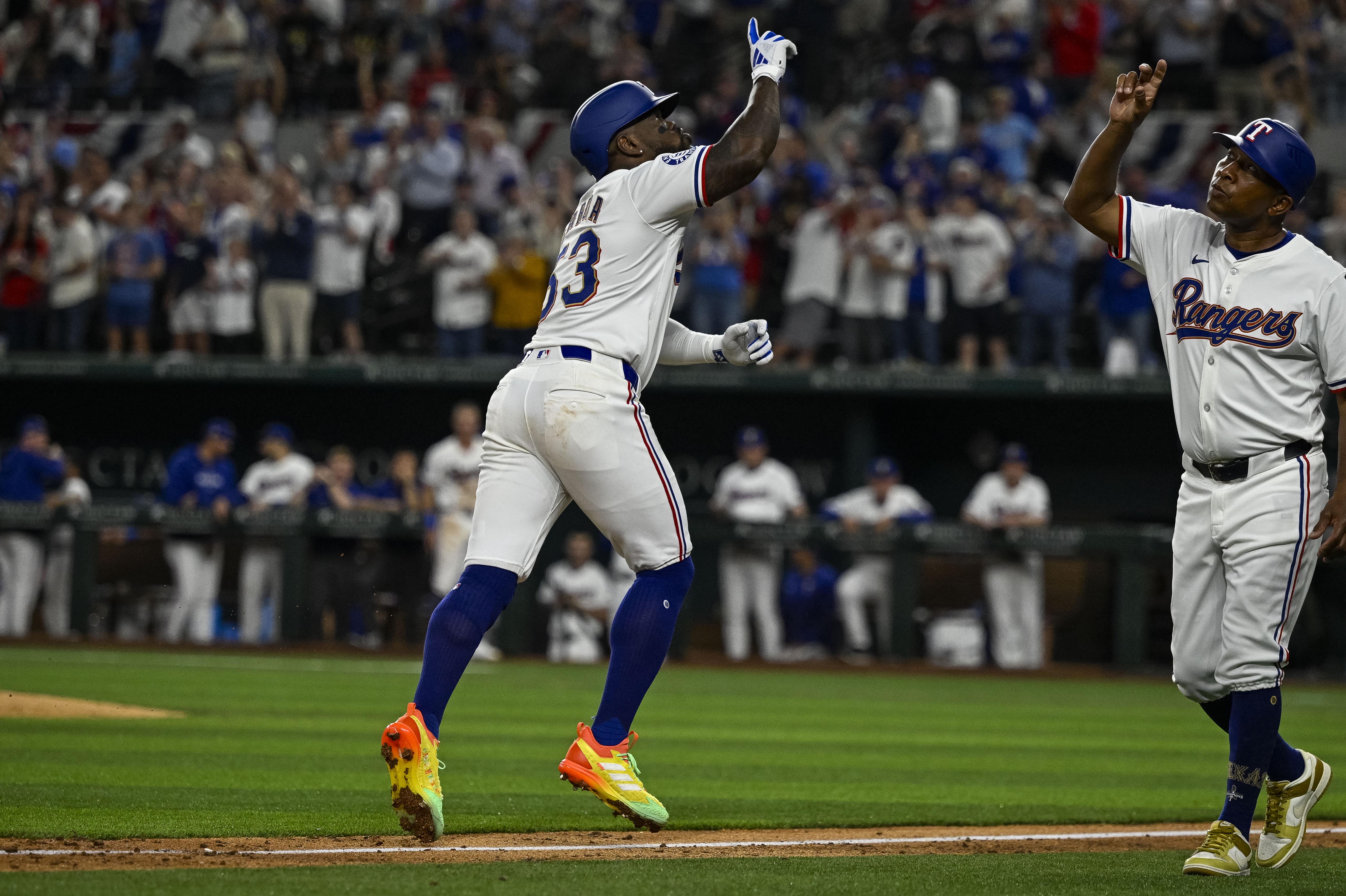 Texas Rangers right fielder Adolis Garcia hits a home run.