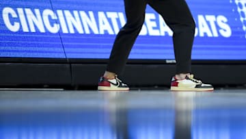 Dec 14, 2024; Cincinnati, Ohio, USA; The Nike shoes worn by Cincinnati Bearcats head coach Wes Miller are seen as he works the bench against the Xavier Musketeers in the second half at Fifth Third Arena. Mandatory Credit: Aaron Doster-Imagn Images