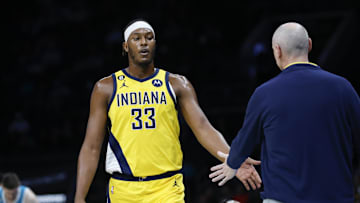 Mar 20, 2023; Charlotte, North Carolina, USA; Indiana Pacers center Myles Turner (33) slaps hands with Indiana Pacers head coach Rick Carlisle as he goes to the bench during the first half against the Charlotte Hornets at Spectrum Center. Mandatory Credit: Nell Redmond-Imagn Images