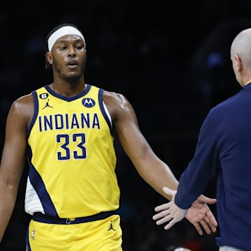 Mar 20, 2023; Charlotte, North Carolina, USA; Indiana Pacers center Myles Turner (33) slaps hands with Indiana Pacers head coach Rick Carlisle as he goes to the bench during the first half against the Charlotte Hornets at Spectrum Center. Mandatory Credit: Nell Redmond-Imagn Images