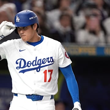 Mar 15, 2025; Bunkyo, Tokyo, Japan; Los Angeles Dodgers designated hitter Shohei Ohtani (17) gestures before batting against the Yomiuri Giants during the first inning at Tokyo Dome. Mandatory Credit: Darren Yamashita-Imagn Images