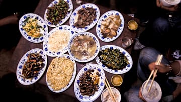 China - Lugu lake - Yunnan province - a Mo Suo minorities family having lunch.