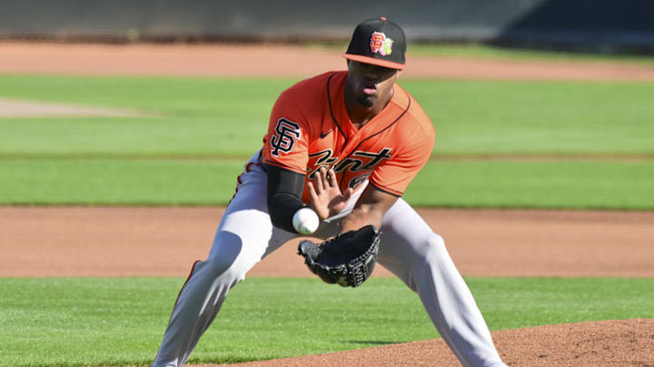 Feb 10, 2026; Scottsdale, AZ, USA;  San Francisco Giants pitcher Joel Peguero (63) fields a ball during a Spring Training workout at Scottsdale Stadium Mandatory Credit: Matt Kartozian-Imagn Images