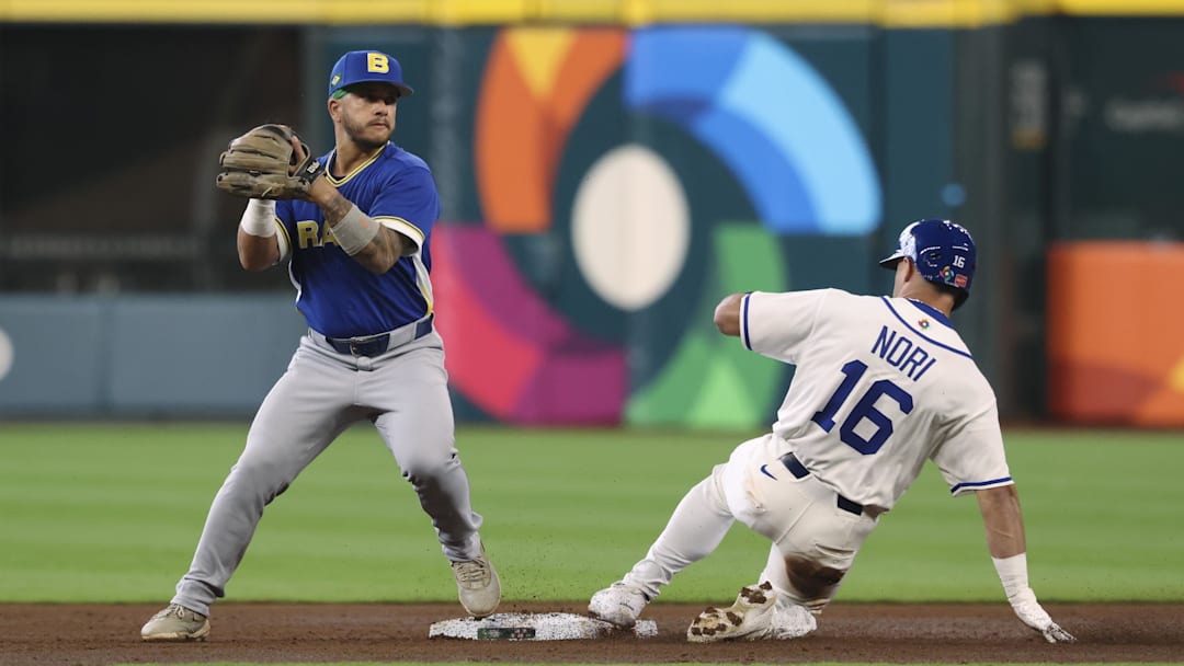 Mar 7, 2026; Houston, TX, United States; Italy left fielder Dante Nori (16) is out at second base as Brazil second baseman Lucas Rojo (15) fields a throw during the third inning at Daikin Park. Mandatory Credit: Troy Taormina-Imagn Images