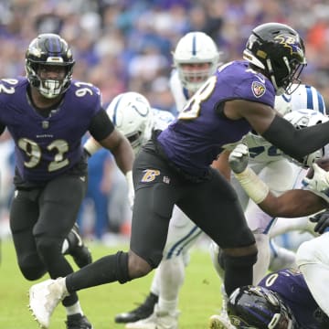 Sep 24, 2023; Baltimore, Maryland, USA; Baltimore Ravens linebacker Jeremiah Moon (48) and linebacker Roquan Smith (0)  tackle Indianapolis Colts running back Zack Moss (21) during the second half  at M&T Bank Stadium. Mandatory Credit: Tommy Gilligan-USA TODAY Sports