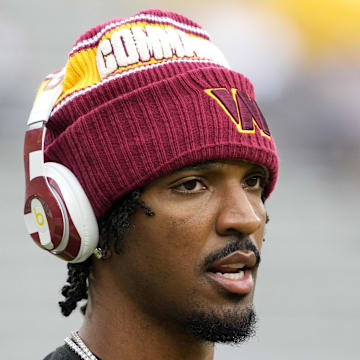 Sep 11, 2025; Green Bay, Wisconsin, USA; Washington Commanders quarterback Jayden Daniels (5) warms up before a game against the Green Bay Packers at Lambeau Field. Mandatory Credit: Jeff Hanisch-Imagn Images