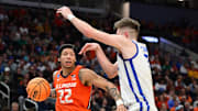 Mar 23, 2025; Milwaukee, WI, USA;  Illinois Fighting Illini guard Tre White (22) drives against Kentucky Wildcats forward Andrew Carr (7) during the first half in the second round of the NCAA Tournament at Fiserv Forum. Mandatory Credit: Benny Sieu-Imagn Images