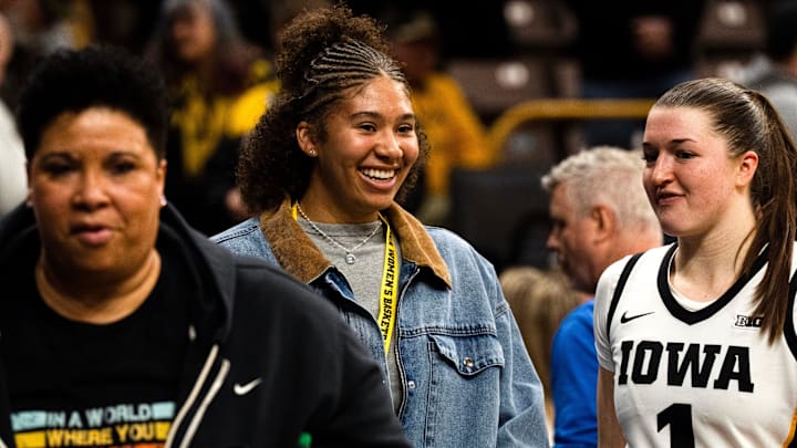 Iowa women’s basketball recruit Nation Williams talks to Iowa guard Taylor Stremlow (1) after the Hawkeyes basketball game against the Michigan Wolverines Feb. 22, 2026 at Carver-Hawkeye Arena in Iowa City, Iowa.