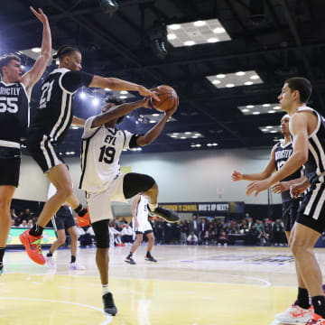 Feb 18, 2024; Indianapolis, Indiana, USA; Team ELY guard Ashton Hagans (19) of the Rip City Remix looks to play the ball defined by Team Strictly forward Cole Swider (21) of the Sioux Falls Skyforce during the G-League Next Up game at Indiana Convention Center. Mandatory Credit: Trevor Ruszkowski-USA TODAY Sports