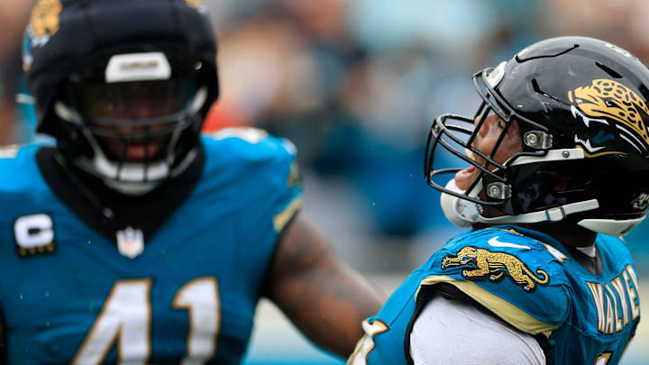 Jacksonville Jaguars defensive end Travon Walker (44) reacts to forcing a fumble with defensive end Josh Hines-Allen (41) during the second quarter of an NFL football matchup Sunday, Oct. 6, 2024 at EverBank Stadium in Jacksonville, Fla. 