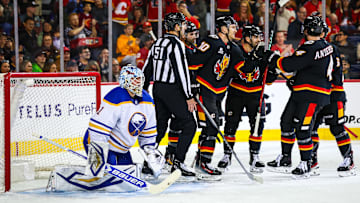 Dec 8, 2025; Calgary, Alberta, CAN; Calgary Flames left wing Jonathan Huberdeau (10) scores a goal against Buffalo Sabres goaltender Ukko-Pekka Luukkonen (1) during the second period at Scotiabank Saddledome. Mandatory Credit: Sergei Belski-Imagn Images