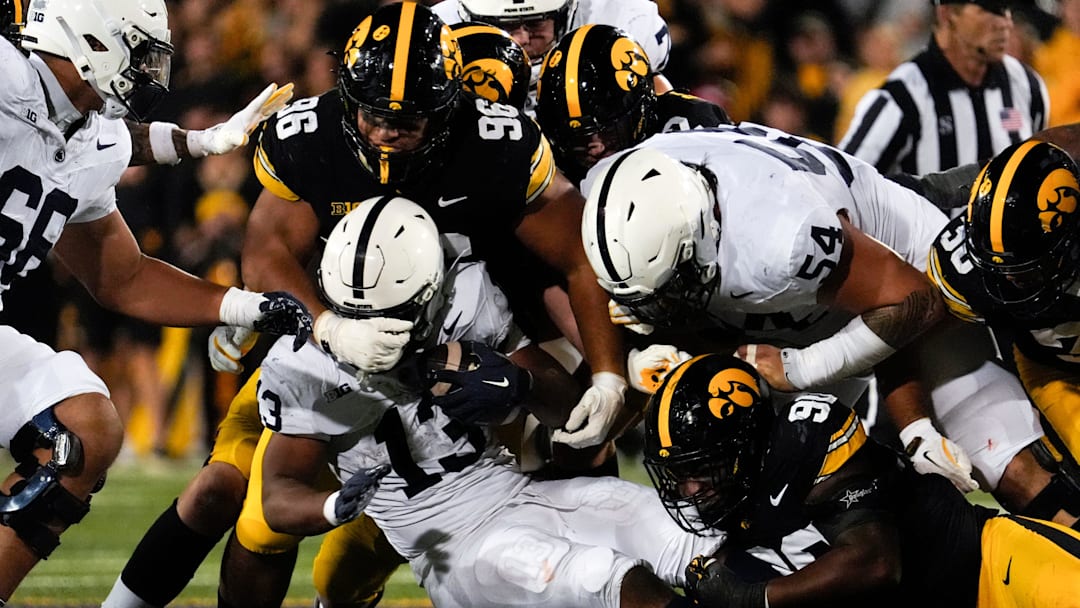 Iowa Hawkeyes defensive lineman Bryce Hawthorne (96) and Iowa Hawkeyes defensive end Brian Allen (90) tackle Penn State Nittany Lions running back Kaytron Allen (13) during a college football game Oct. 18, 2025 at Kinnick Stadium in Iowa City, Iowa.