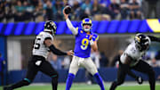 Dec 5, 2021; Inglewood, California, USA; Los Angeles Rams quarterback Matthew Stafford (9) throws as Jacksonville Jaguars defensive end Roy Robertson-Harris (95) moves in during the second half at SoFi Stadium. Mandatory Credit: Gary A. Vasquez-Imagn Images