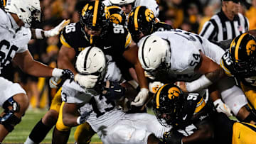 Iowa Hawkeyes defensive lineman Bryce Hawthorne (96) and Iowa Hawkeyes defensive end Brian Allen (90) tackle Penn State Nittany Lions running back Kaytron Allen (13) during a college football game Oct. 18, 2025 at Kinnick Stadium in Iowa City, Iowa.