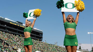 Oregon cheerleaders lead fans in a cheer during the Duck’s game against Oklahoma State at Autzen.
