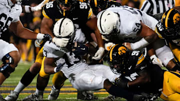 Iowa Hawkeyes defensive lineman Bryce Hawthorne (96) and Iowa Hawkeyes defensive end Brian Allen (90) tackle Penn State Nittany Lions running back Kaytron Allen