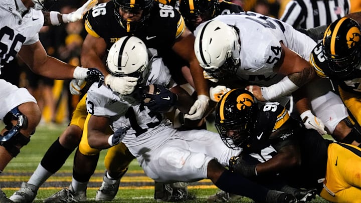 Iowa Hawkeyes defensive lineman Bryce Hawthorne (96) and Iowa Hawkeyes defensive end Brian Allen (90) tackle Penn State Nittany Lions running back Kaytron Allen