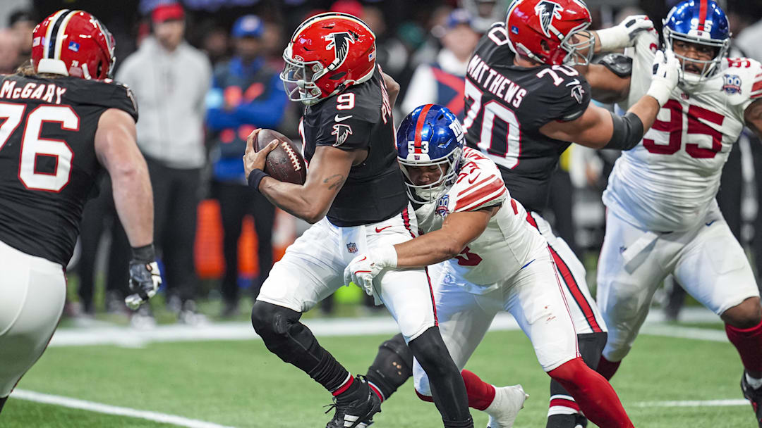 Dec 22, 2024; Atlanta, Georgia, USA; New York Giants linebacker Darius Muasau (53) sacks Atlanta Falcons quarterback Michael Penix Jr. (9) during the first half at Mercedes-Benz Stadium. 